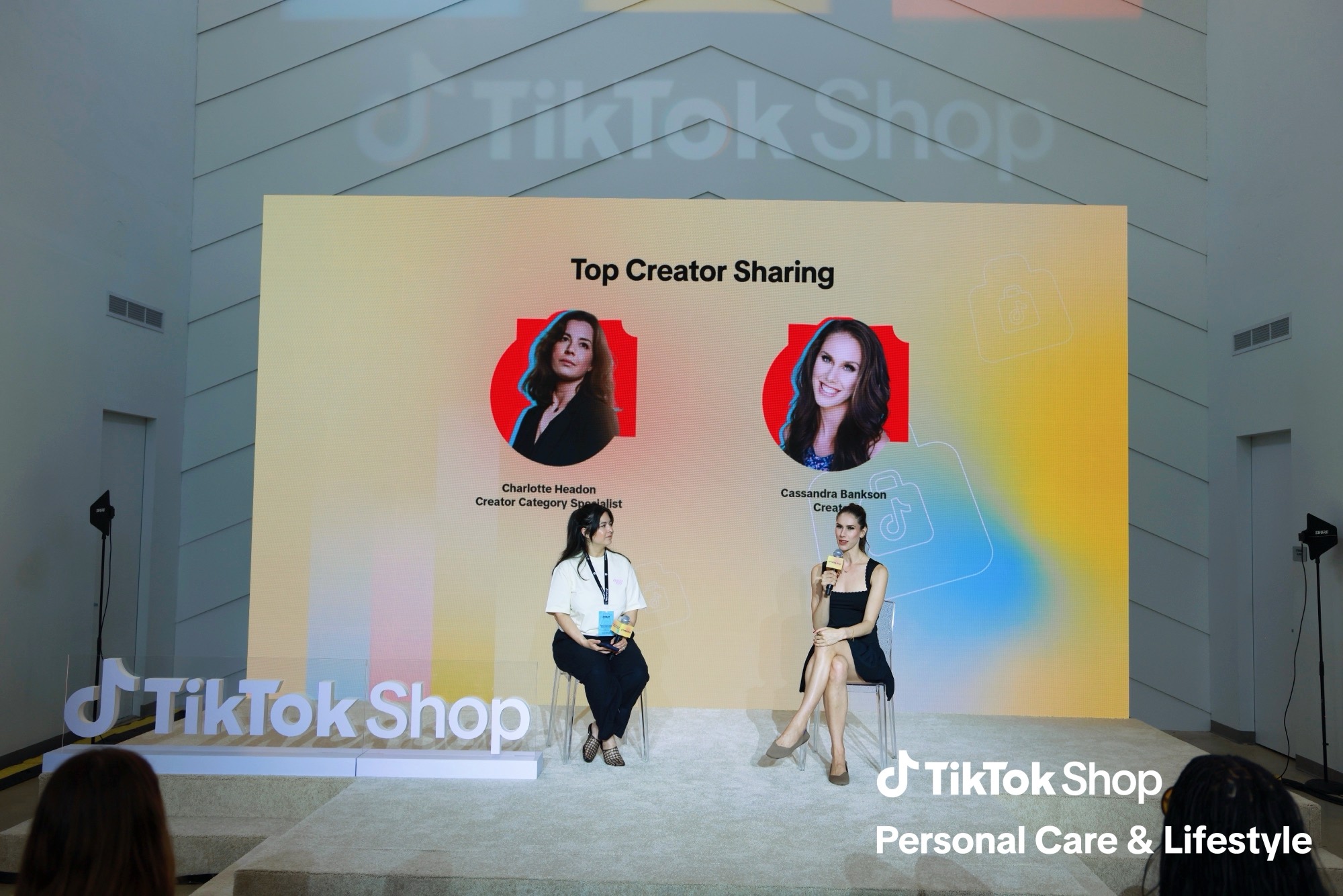 Cassandra Bankson on the Top Creator Sharing stage at the TikTok Shop Summer Seller Summit in Miami, her name on the screen behind her